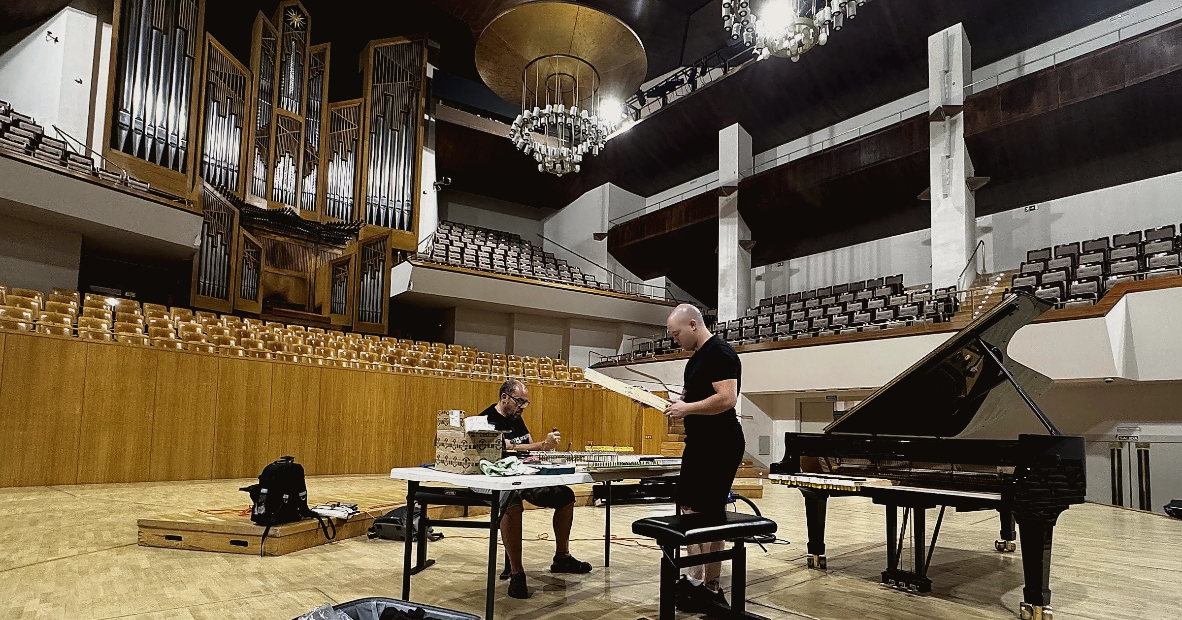 Luis Izquierdo with his father working on a concert piano