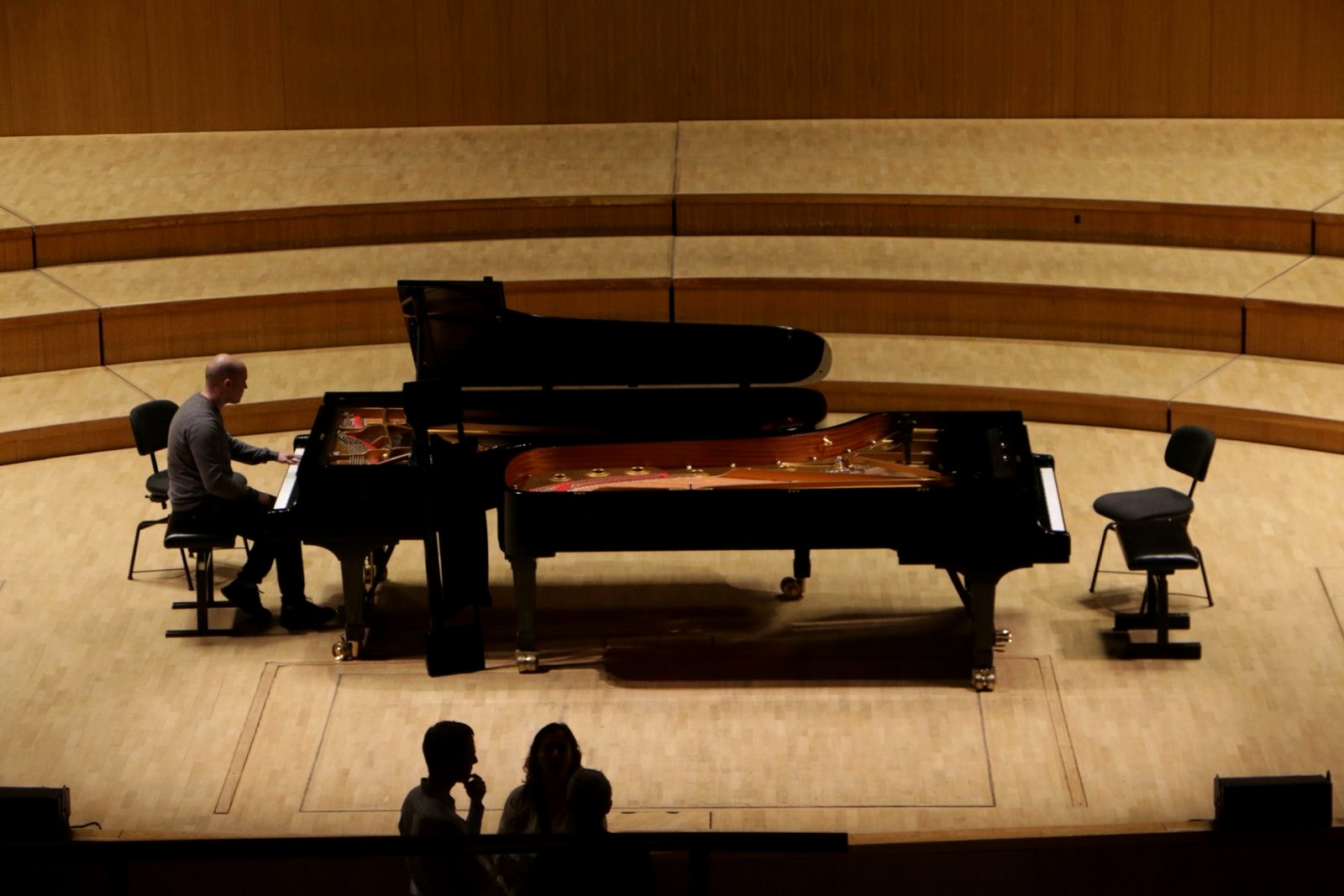 Two grand pianos in a concert setting